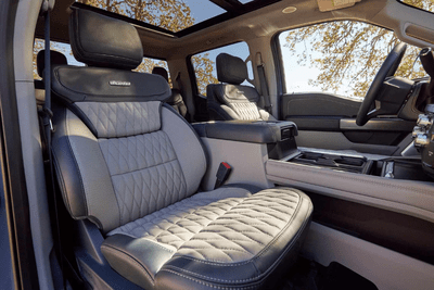 Interior view of the 2024 Ford F-250 Limited, showing the leather seats, steering wheel, and moonroof.