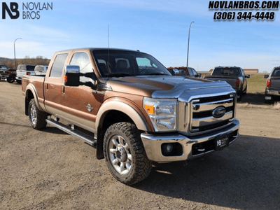 A beige 2011 Ford F-350 Lariat for sale at the Novlan Bros dealership in Saskatchewan.