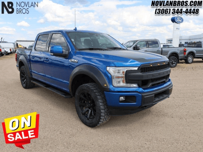 A blue 2018 Ford F-150 Lariat for sale at the Novlan Bros dealership in Saskatchewan.