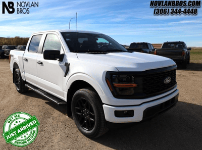 A white 2024 Ford F-150 STX for sale at the Novlan Bros dealership in Saskatchewan.