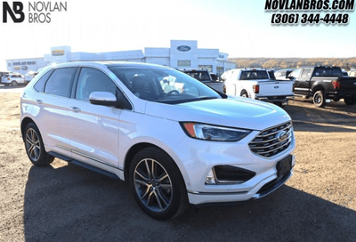 A white 2019 Ford Edge Titanium for sale at the Novlan Bros dealership in Saskatchewan.