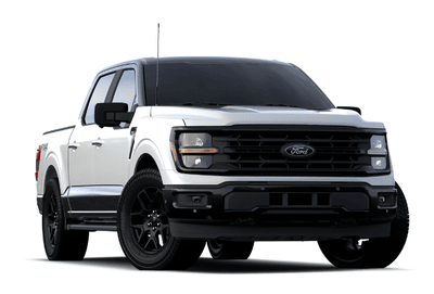 A white 2024 Ford F-150 XLT equipped with the Heritage Appearance Edition and posed against a white background.