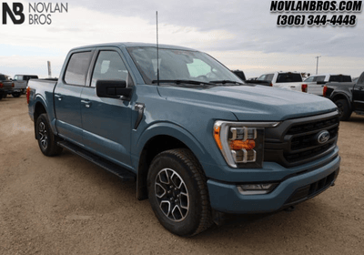 A blue 2023 Ford F-150 XLT for sale at the Novlan Bros dealership in Saskatchewan.