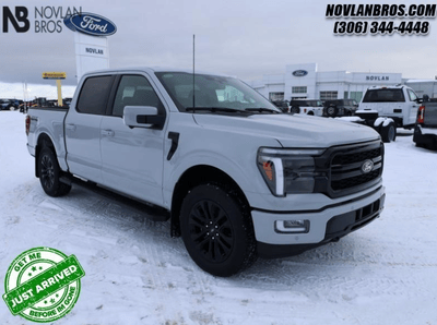 A white 2024 Ford F-150 Lariat for sale at the Novlan Bros dealership in Saskatchewan.