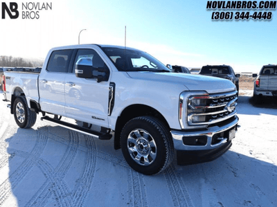 A white 2024 Ford F-350 Super Duty Lariat for sale at the Novlan Bros dealership in Saskatchewan.