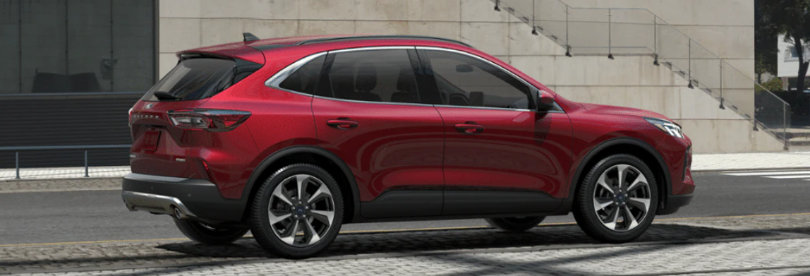 A red 2024 Ford Escape Platinum shown in profile and parked in front of concrete steps.