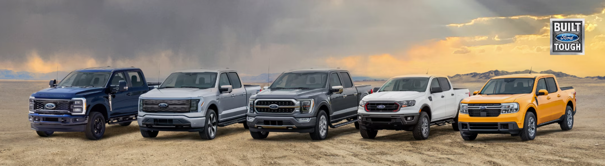 The 2025 Ford truck line-up - which includes the F-150, F-250, F-250, Ranger, and Maverick - parked in a desert.