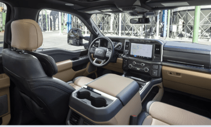 Interior view of the 2023 Ford F-350 Lariat Super Duty, showcasing the tan leather seating, the dash, and SYNC 4 console.