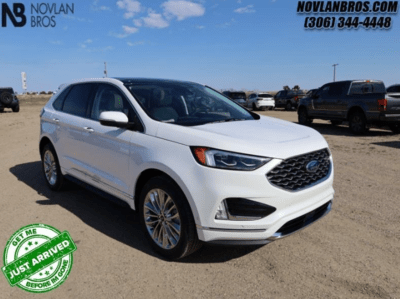 A white 2024 Ford Edge Titanium for sale at the Novlan Bros dealership in Saskatchewan.