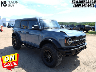 A blue 2024 Ford Bronco Wildtrak for sale at the Novlan Bros dealership in Saskatchewan.