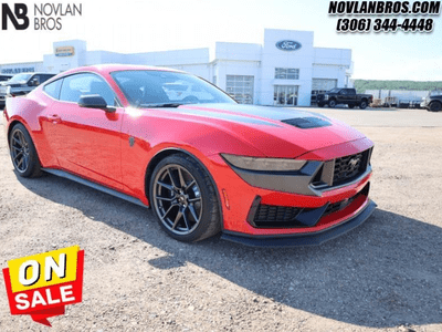 A red 2024 Ford Mustang Dark Horse for sale at the Novlan Bros dealership in Saskatchewan.