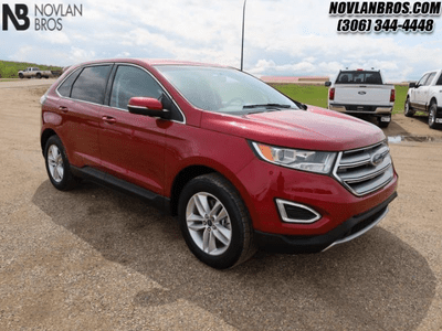 A red 2018 Ford Edge SEL for sale at the Novlan Bros dealership in Saskatchewan.