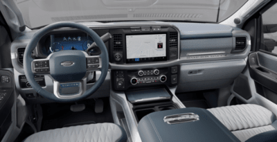 Interior view of the 2023 Ford F-250 Limited, displaying the steering wheel, SYNC 4 screen, and leather seats.