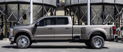 A silver 2023 Ford F-250 Super Duty parked in an industrial area.