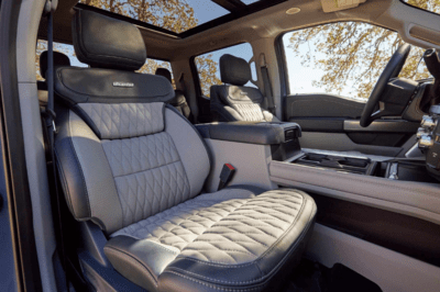 Interior view of the 2023 Ford F-350 Super Duty, showcasing the quilted leather seats and gray suede appliques.