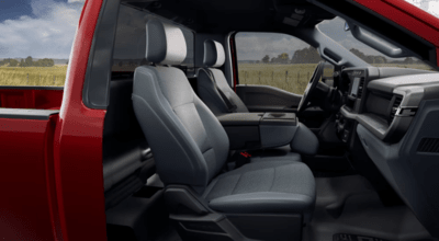 Interior view of a 2023 Ford F-350 XL, with the two-seat cabin, dashboard, and steering wheel shown.