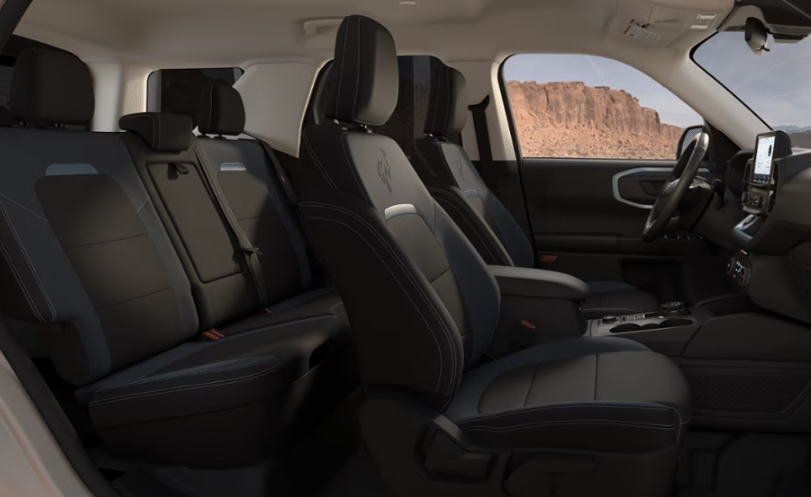 Interior view of the 2024 Ford Bronco Sport Badlands, showcasing black seats, the steering wheel, and the digital media center.