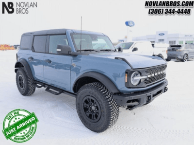 A blue 2024 Ford Bronco Wildtrak parked at the Novlan Bros dealership in Saskatchewan.