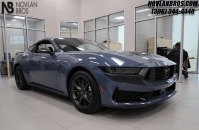 A grey 2024 Ford Mustang Dark Horse parked inside the Novlan Bros showroom in Saskatchewan.