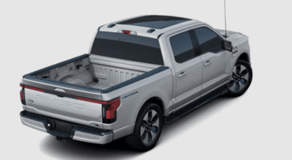 Rear view of a grey 2023 Ford F-150 Lightning, showcasing the bed, tailgate, and LED lighting.