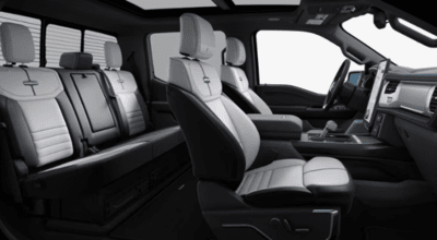 Interior view of the 2023 Ford F-150 Lightning Platinum, with the leather seats, dash, and steering wheel displayed.