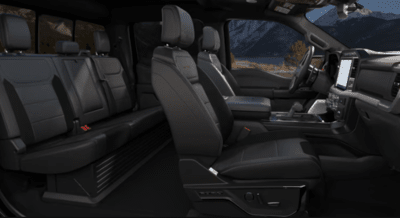 Interior view of the 2023 Ford F-150 Raptor, showing the leather seats, steering wheel, and SYNC 4 screen.