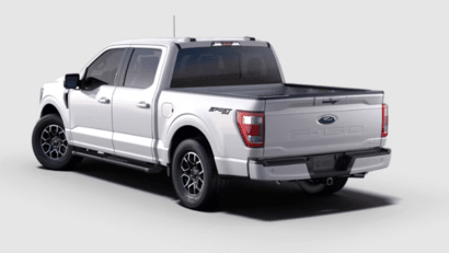 A white 2023 Ford F-150 Lariat shown from the rear and equipped with the Sport Package.