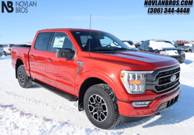 A red 2023 Ford F-150 XLT parked at the Novlan Bros dealership in Saskatchewan.