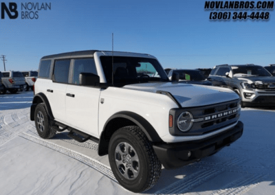 A white 2024 Ford Bronco Big Bend parked at the Novlan Bros dealership in Saskatchewan.