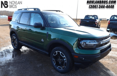 A green 2024 Ford Bronco Sport Outer Banks parked at the Novlan Bros dealership in Saskatchewan.