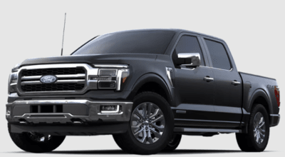 A black 2024 Ford F-150 Lariat posed against a white background.