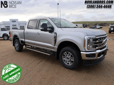 A silver 2024 Ford F-350 Lariat Super Duty for sale at the Novlan Bros dealership in Saskatchewan.