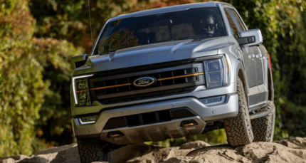 A silver  2023 Ford F-150 Tremor driving over rocky terrain.