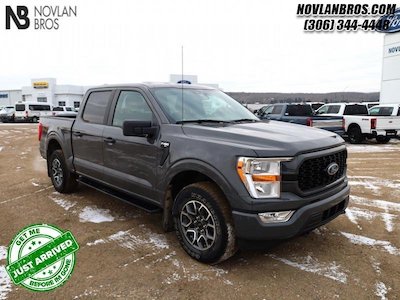 A gray 2021 Ford F-150 XL parked at the Novlan Bros dealership in Lloydminster, SK.