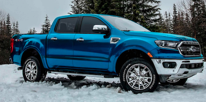 A blue 2023 Ford Ranger Lariat equipped with the Chrome Appearance Package and parked in the snow.